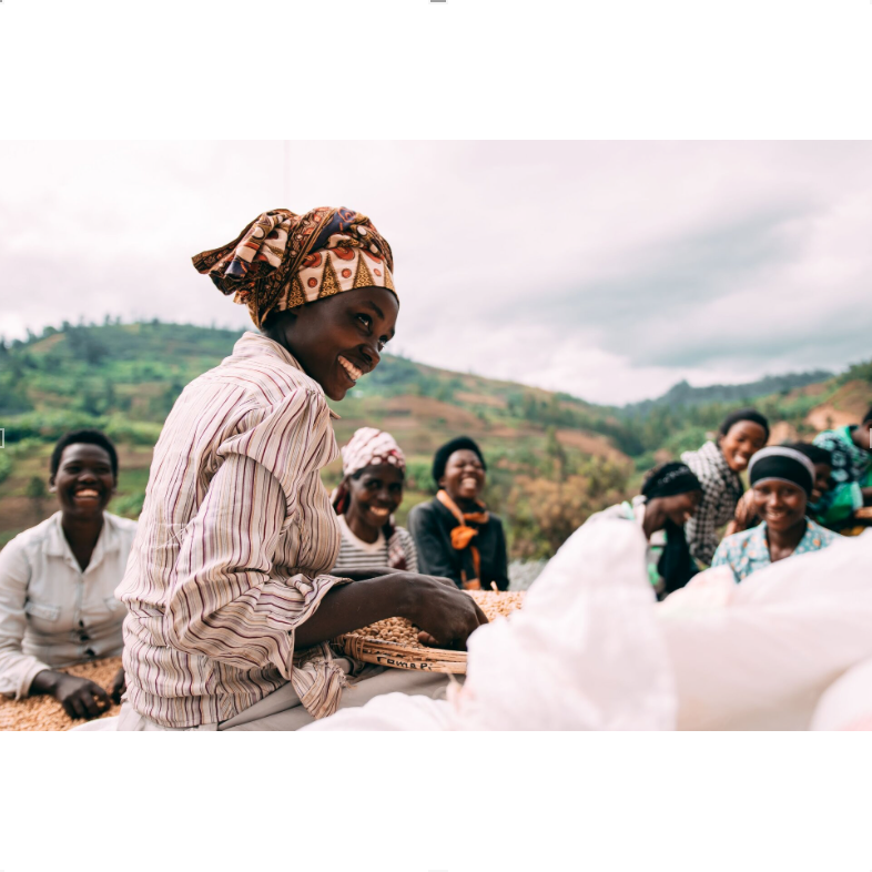 Women sitting on washing station, helping sort coffee ready for bagging