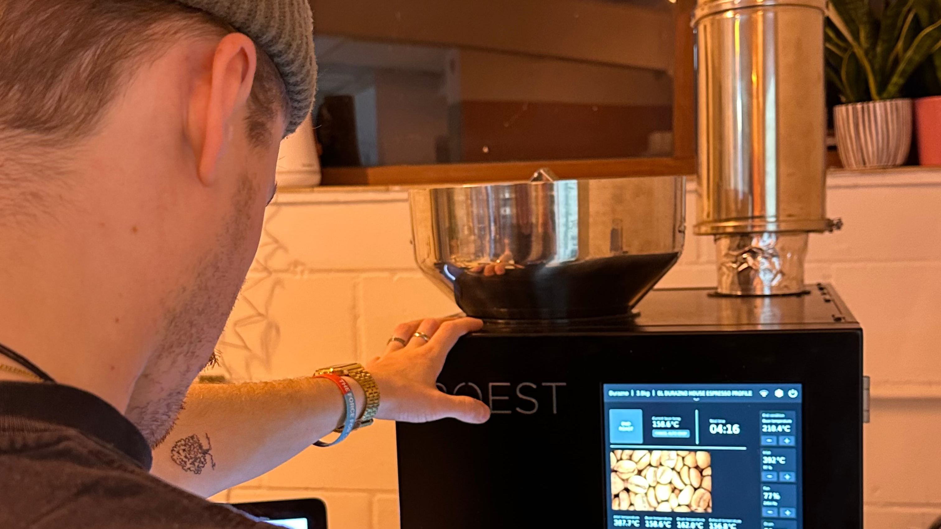 Person using a coffee machine with a digital display